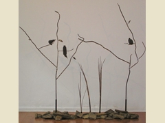 Two steel trees with rocks