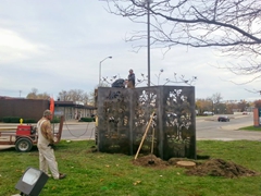 Joe Hottinger and an assistant welding the branches and birds to the top of the sculpture.