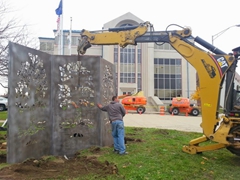 The sculpture placed into the foundation hole in front of the Muncie City Building.
